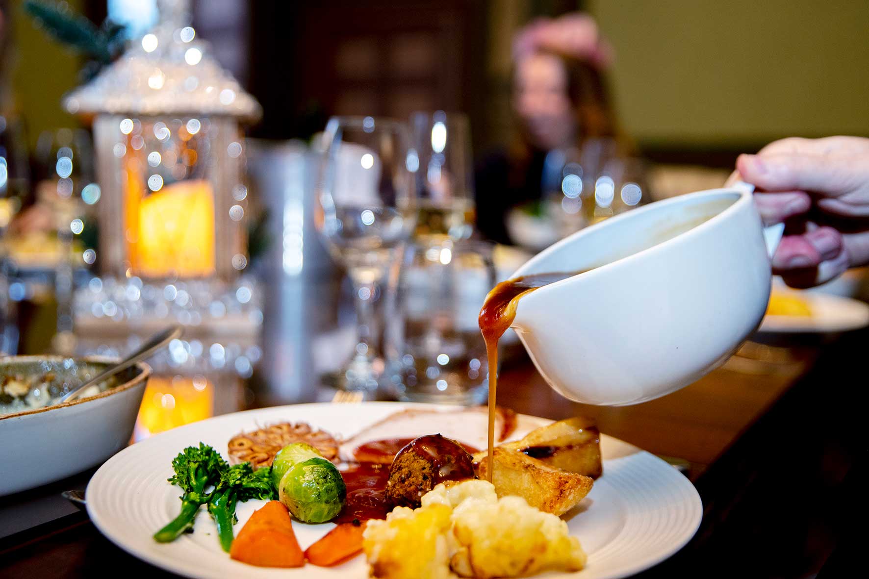 Pouring gravy on a Christmas lunch