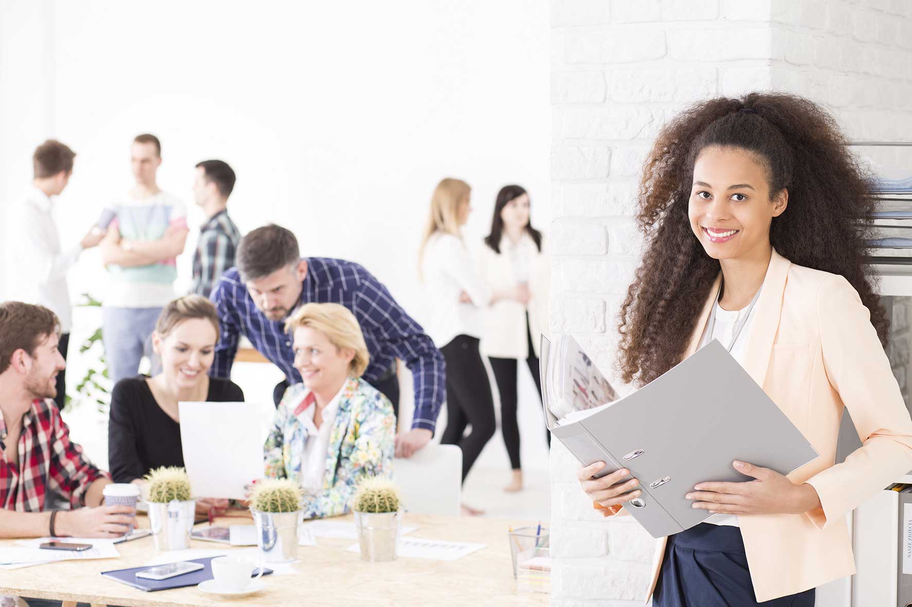 Young woman with her team behind
