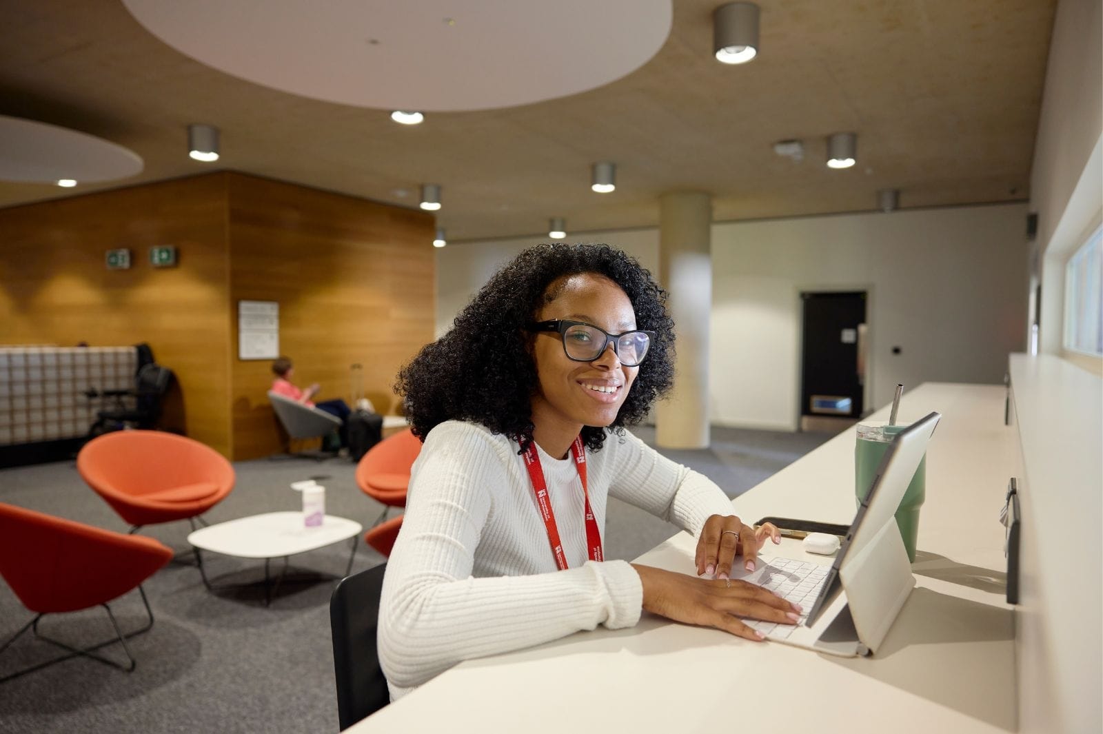 Student smiling at a lap top