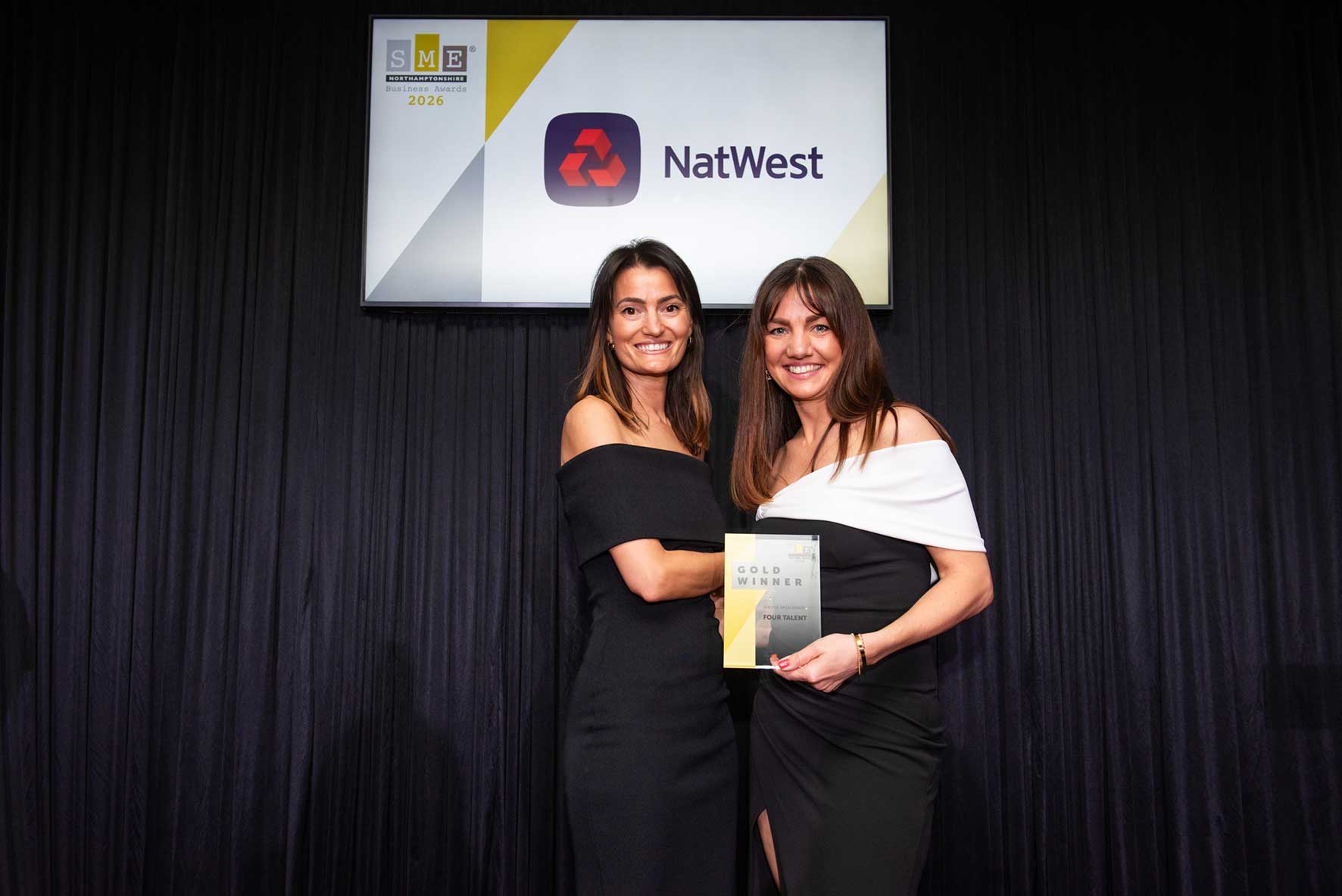 Lucy Wright and Louise Keightley of Four Talent holding SME Business Awards at awards ceremony