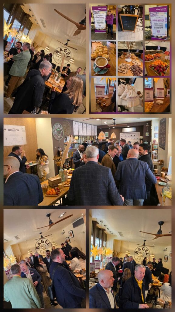 Group of professionals mingling at a cafe event, with pastries and coffee on display near a Bagel Café sign.