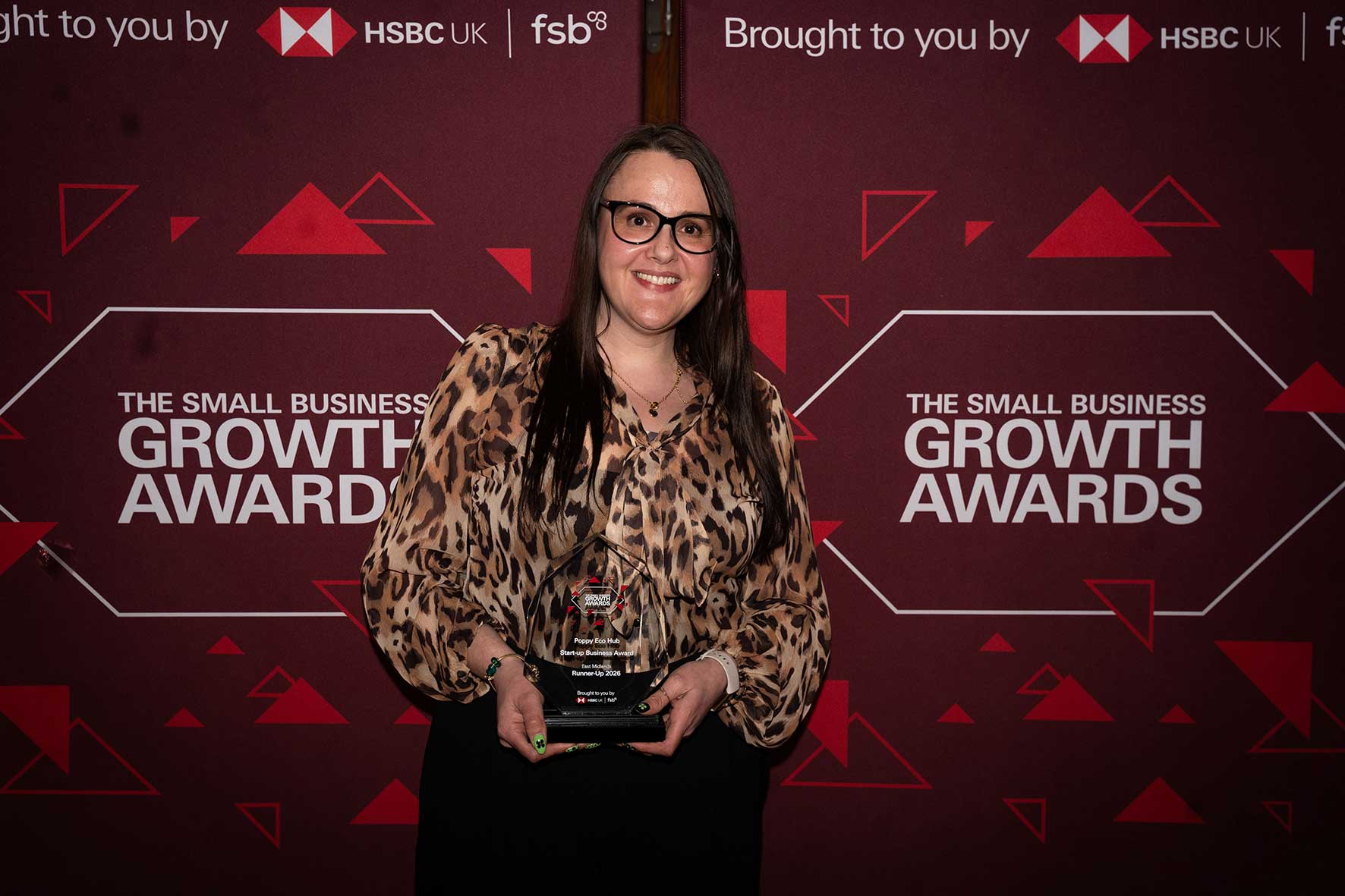 Marie Baker of Poppy Eco Hub holding the Start-up Business Award runner-up trophy at the Small Business Growth Awards 2026.
