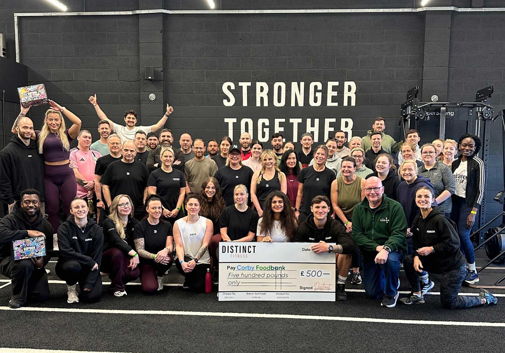 Distinct Fitness members and Corby Foodbank representatives after raising more than £570 during the Spring Games charity fitness event in Corby