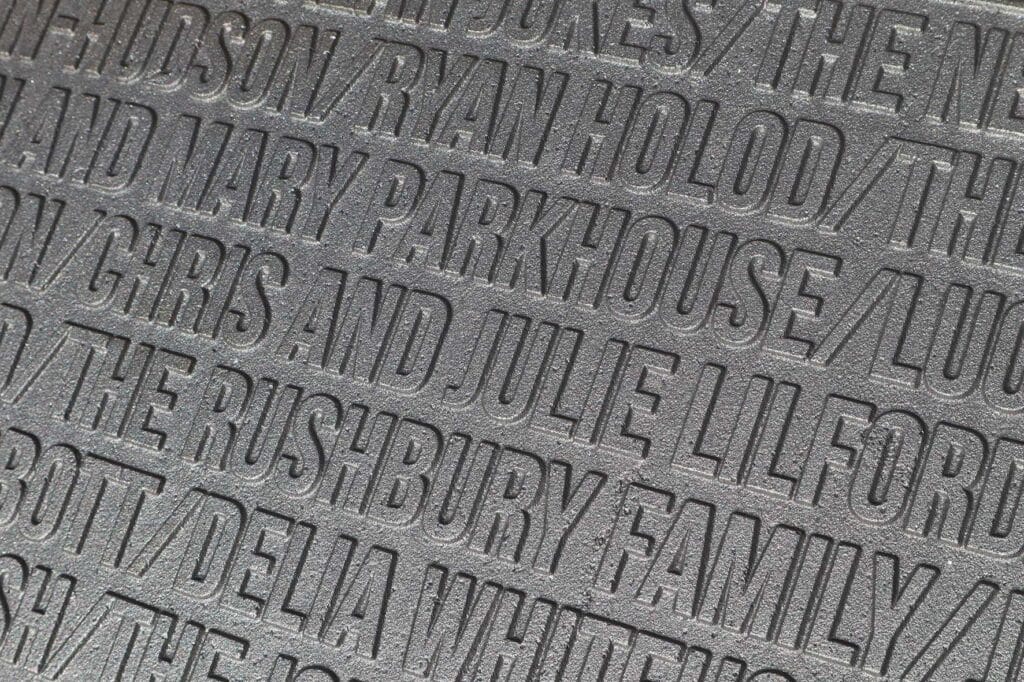 Corten-Paths | Business Times Northamptonshire Close-up of a textured rubber mat with large raised uppercase letters forming repeating text across the surface.