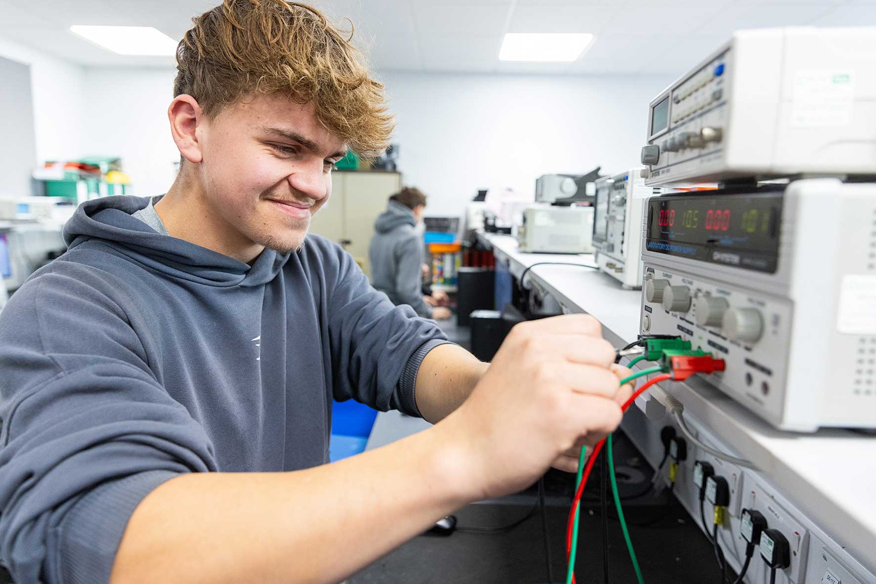 Northampton College student training to become a skilled electrician using electrical testing equipment