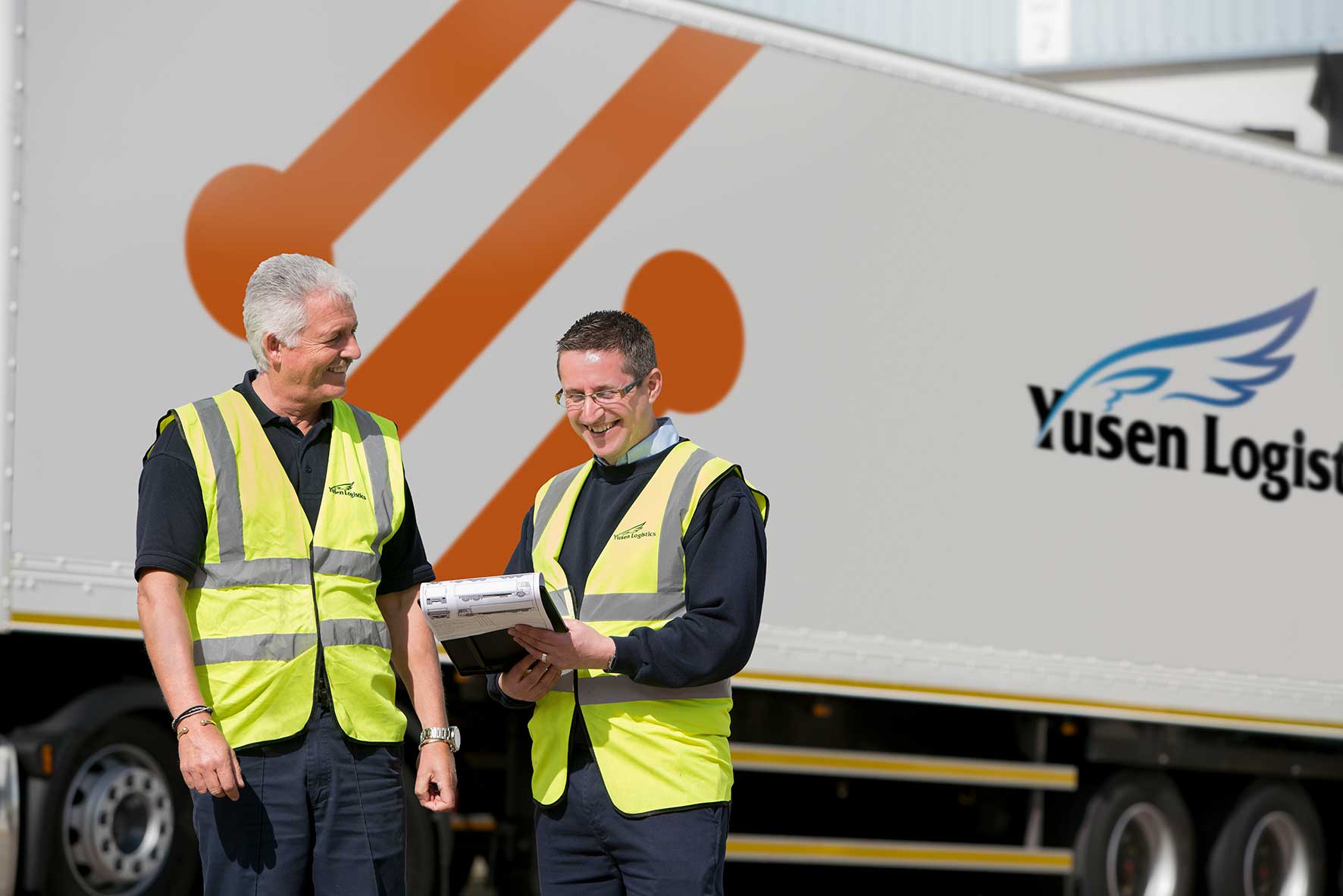 Yusen trailer with driver talking to operative